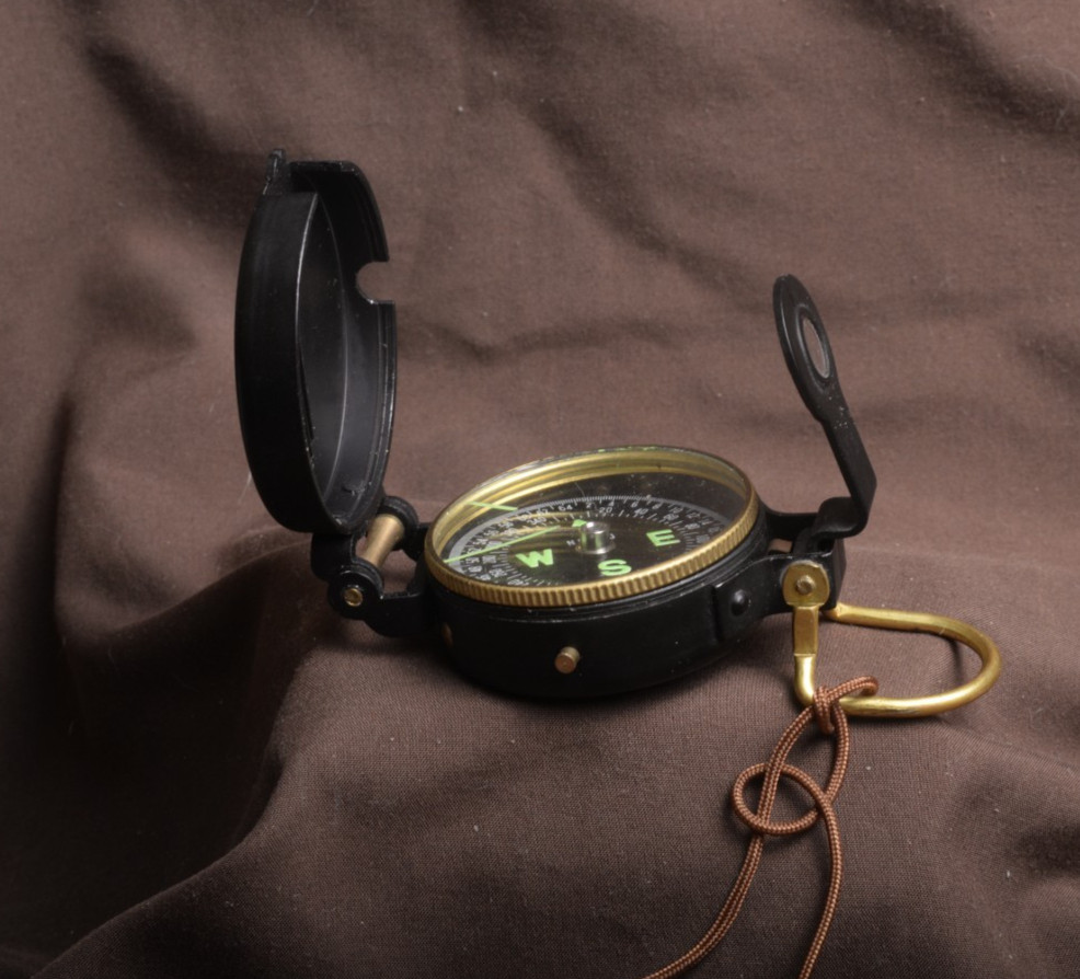 two lensatic compasses one with box