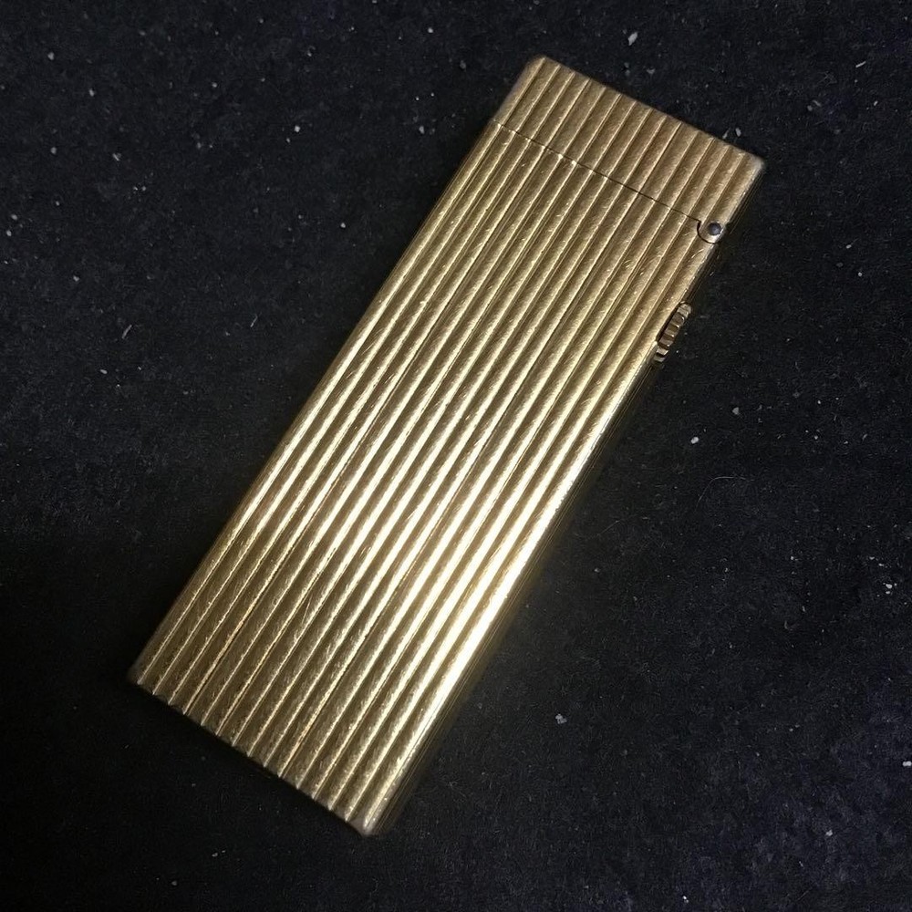 Overhauled gold dunhill lighter with striped pattern, ignition functioning well