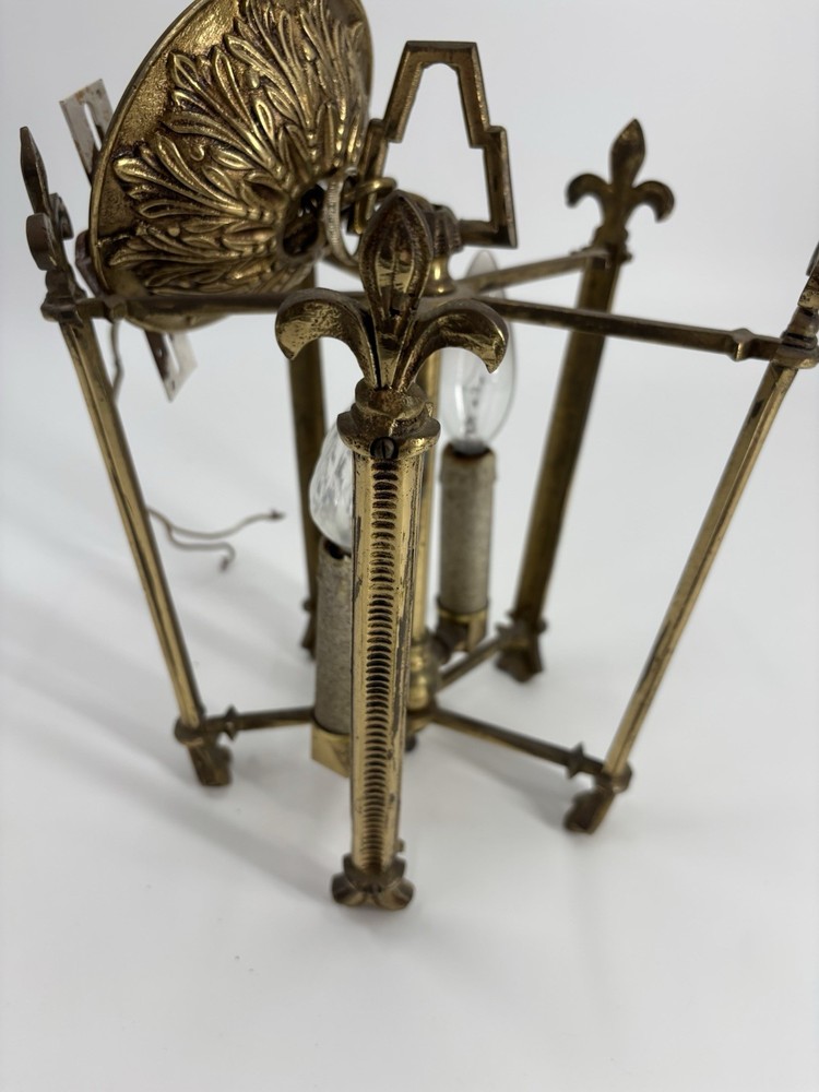 This is an antique lantern chandelier featuring fleur-de-lis finials.