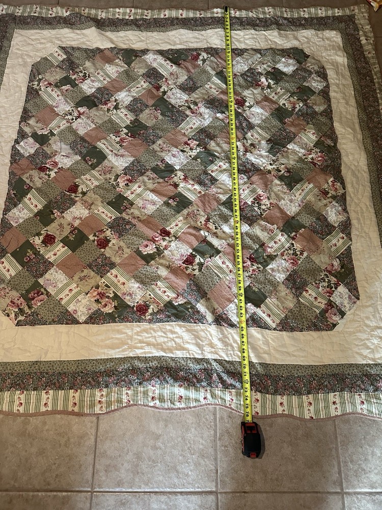 Cutters Handmade floral and striped patchwork quilt with diamond pattern.