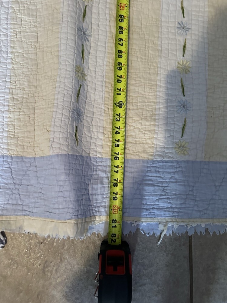 Cutters Handmade quilted bedspread with striped pattern and floral embroidery.