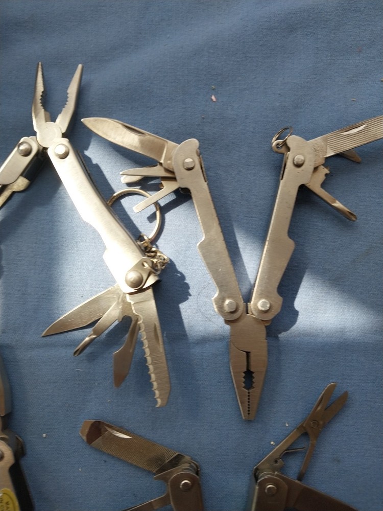 4 small multitudes with pliers knife scissors screwdriver's