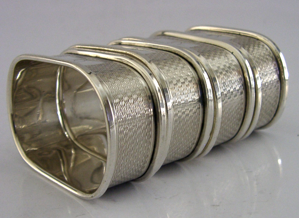 FOUR ENGLISH SOLID STERLING SILVER ENGINE TURNED NAPKIN RINGS 1959/60