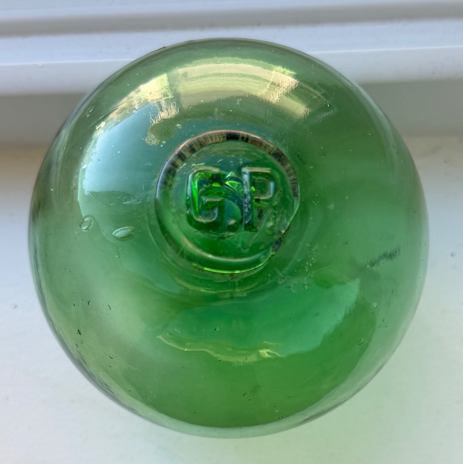 Glass fishing float marked G.P.