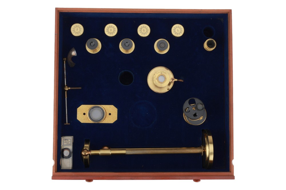 Very large binocular microscope in case with accessories.