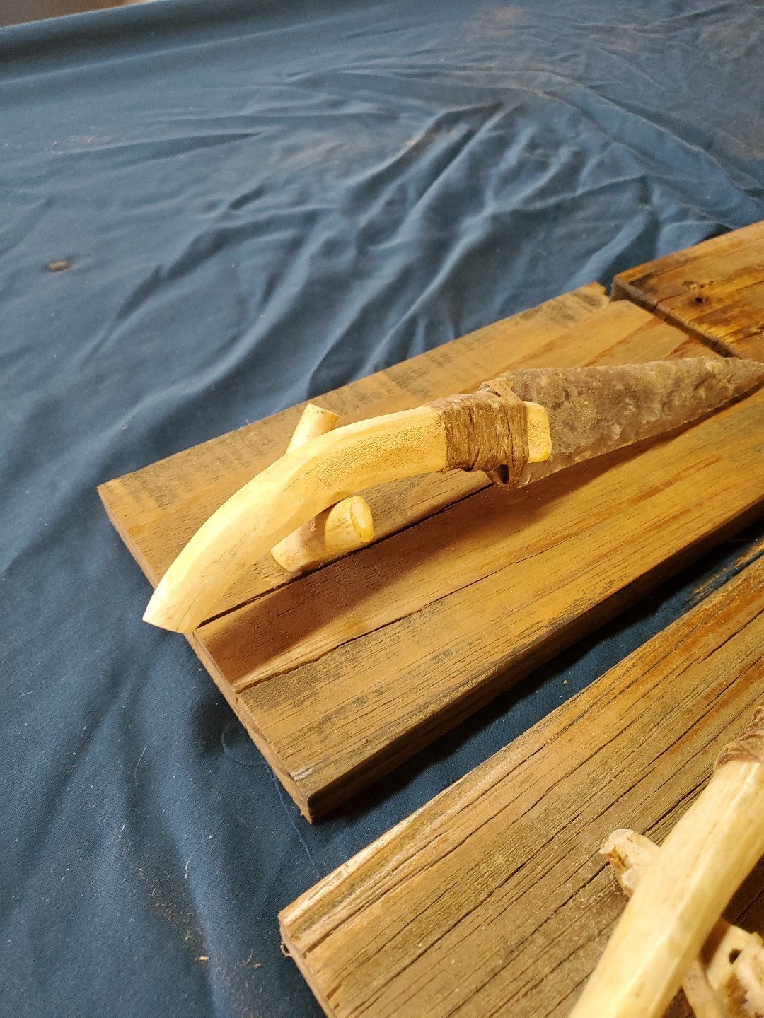 Flint Knapped Stone Arrowhead Blade Knife with Deer Antler Handle on Wood Stand