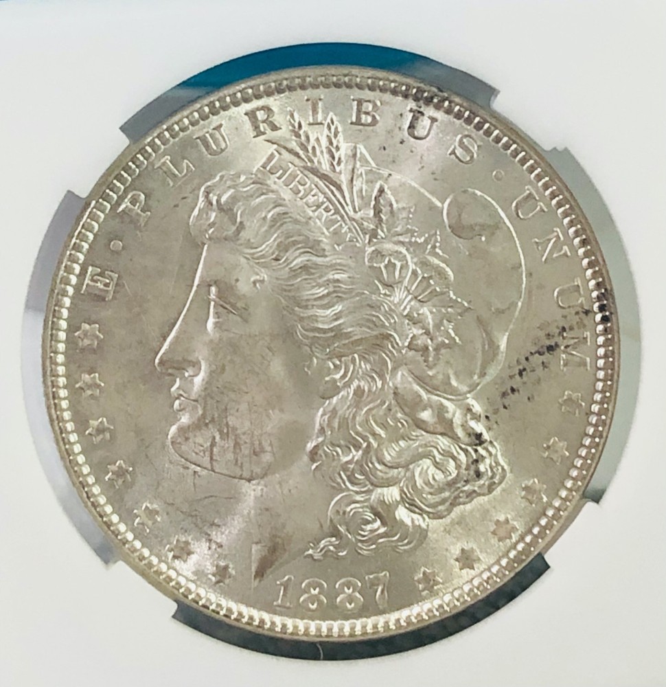 **1887 MORGAN SILVER DOLLAR.**