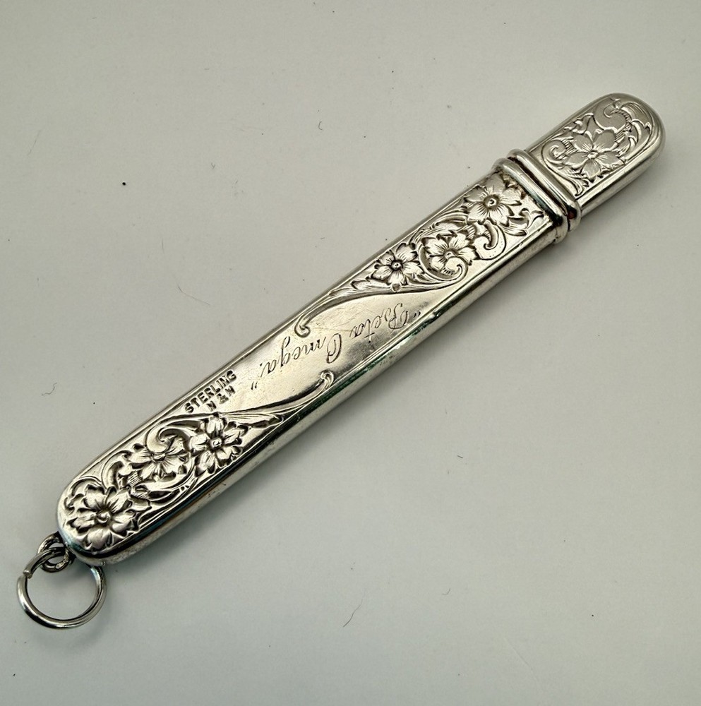 This is an antique sterling silver chatelaine pencil holder