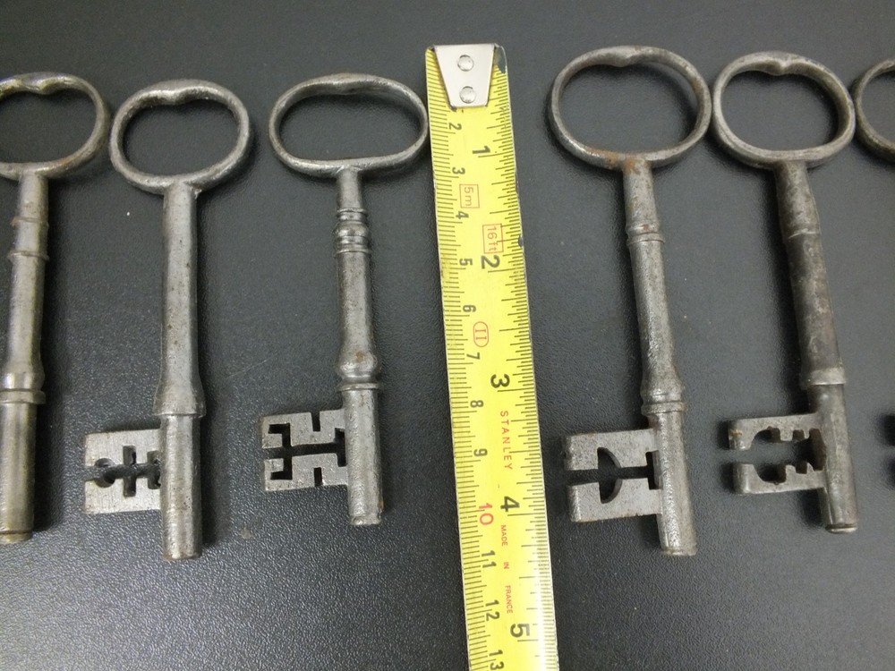 EIGHT ANTIQUE IRON WARDED KEYS .