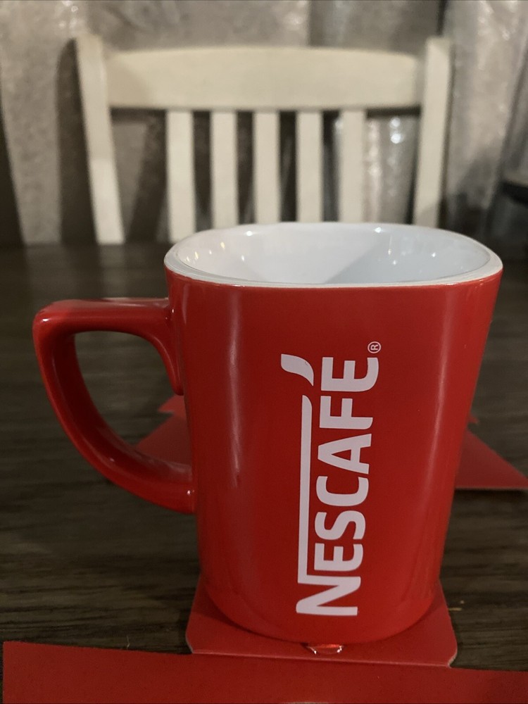 Mug Coffee & 3 packets Inside Dark Roast Nescafe Clasico.