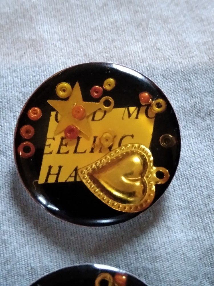 4 Vintage Junque Deco Plastic On Metal Buttons.