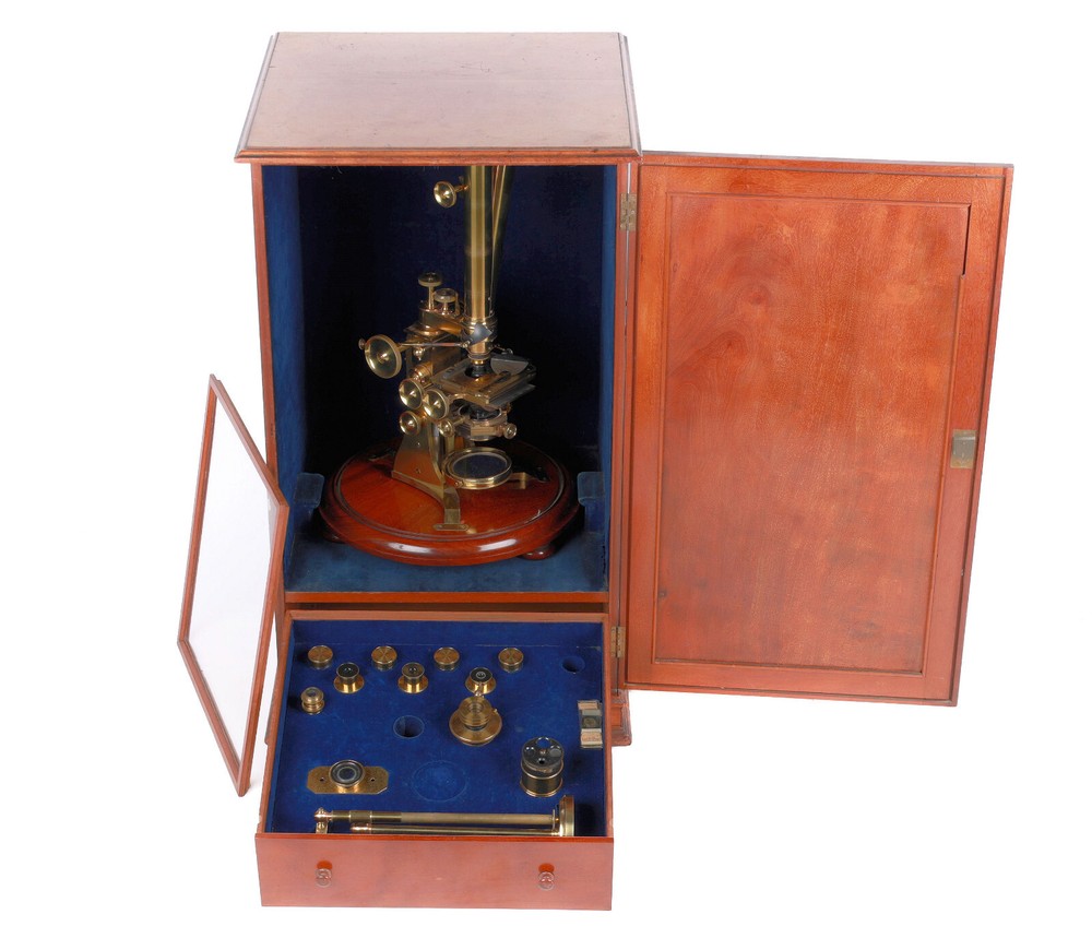 Very large binocular microscope in case with accessories.