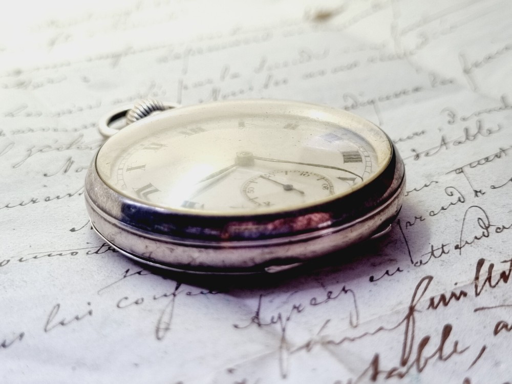 silver open face pocket watch