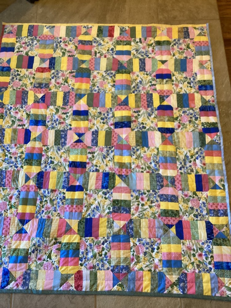 Handmade colorful scrap lap quilt