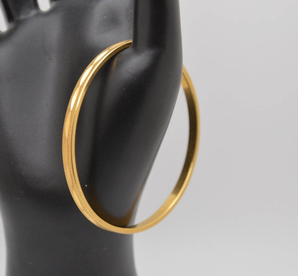 Thin gold bangle bracelet, signed Monet, 163