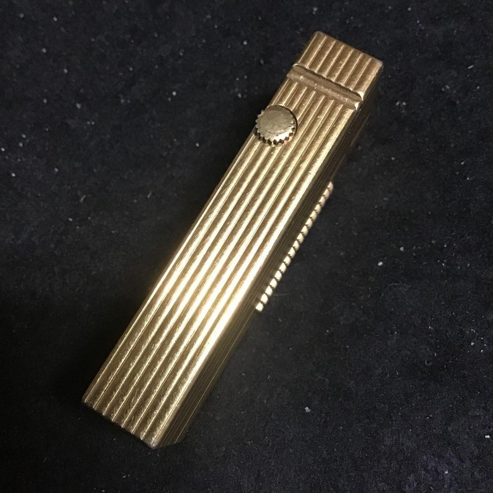 Overhauled gold dunhill lighter with striped pattern, ignition functioning well