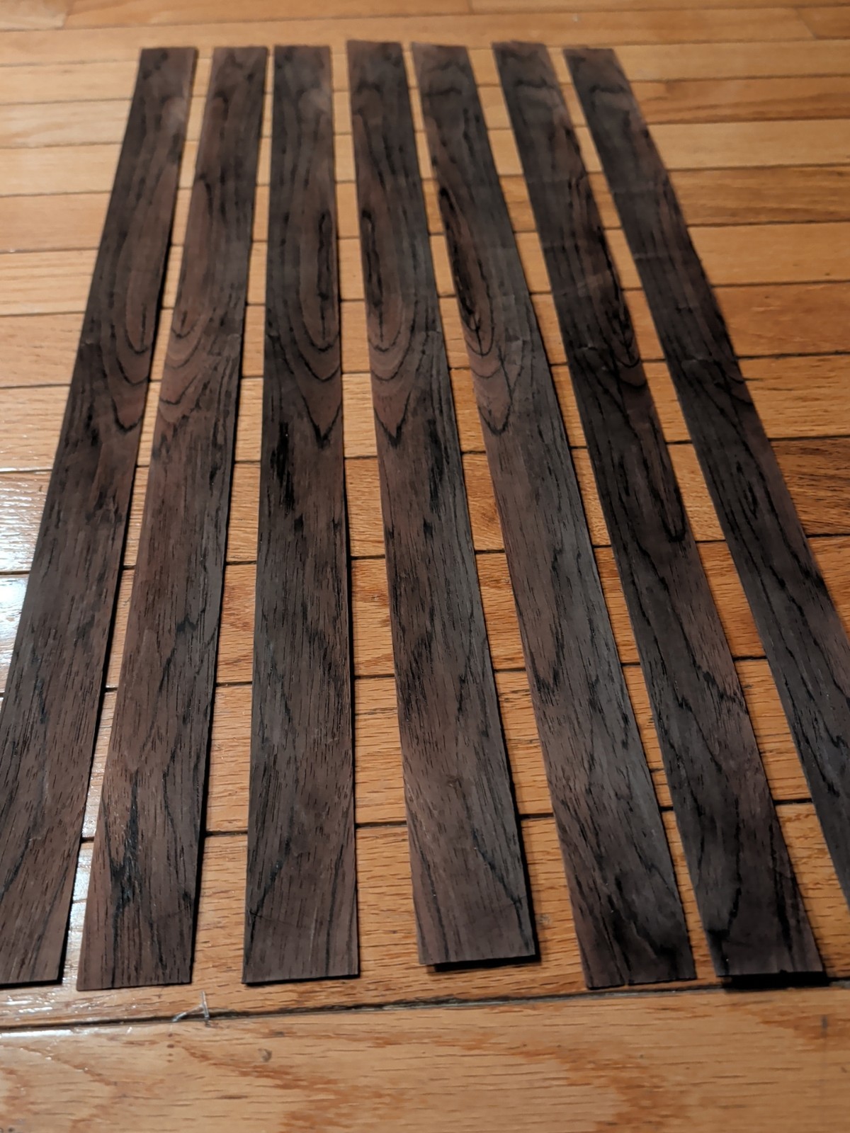 7 pieces of rosewood veneer 1 1/4" to 1 1/2" x 24 1/2" each raw 1/42"