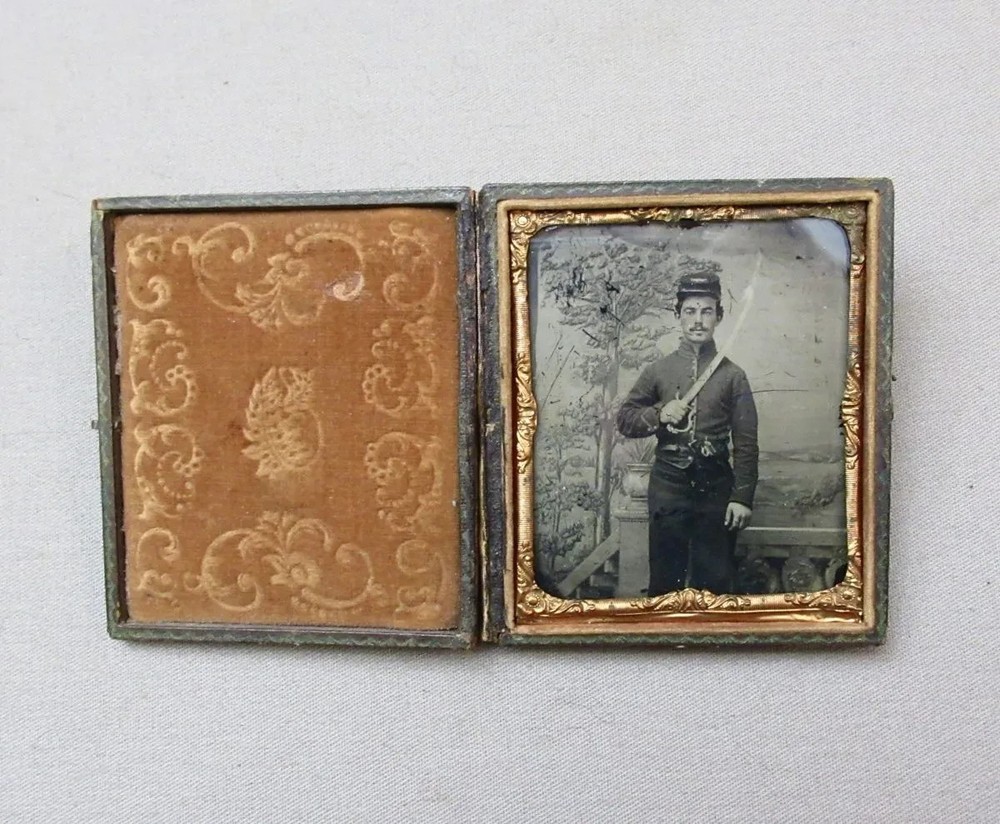 Civil War Ruby Ambrotype – Private Holding Eagle Head Saber & Colt Pocket