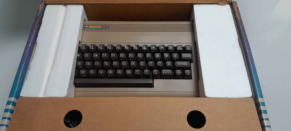 Vintage Commodore 64 computer in box, manuals and programs package