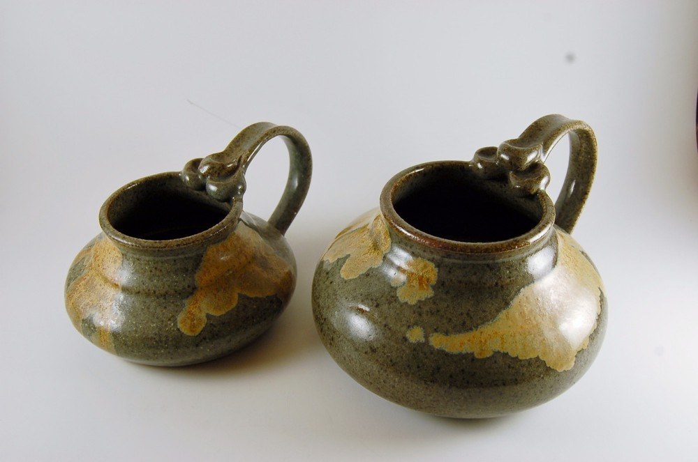Pottery Pitchers. Two Graceful shaped Earth Tone low Pitchers.
