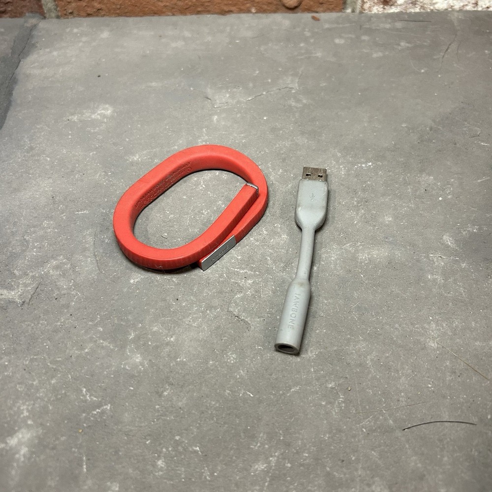 Jawbone UP24 Activity Tracker along with its charging cable Red