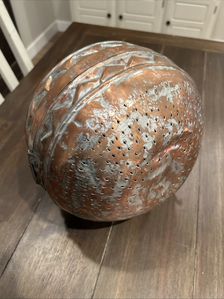 Antique Middle Eastern copper lidded storage container with geometric patterns.
