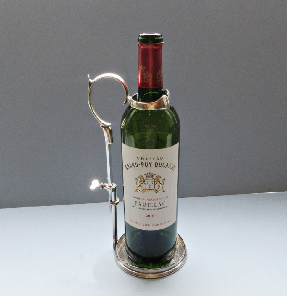 A C1890 silver-plate wine bottle holder by Hukin & Heath,
