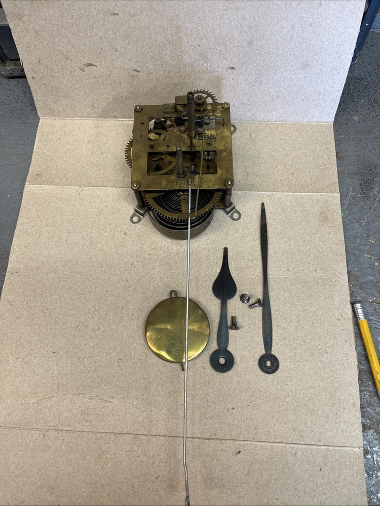 ANTIQUE E INGRAHAM CO CLOCK MOVEMENT AND PENDULUM BOB