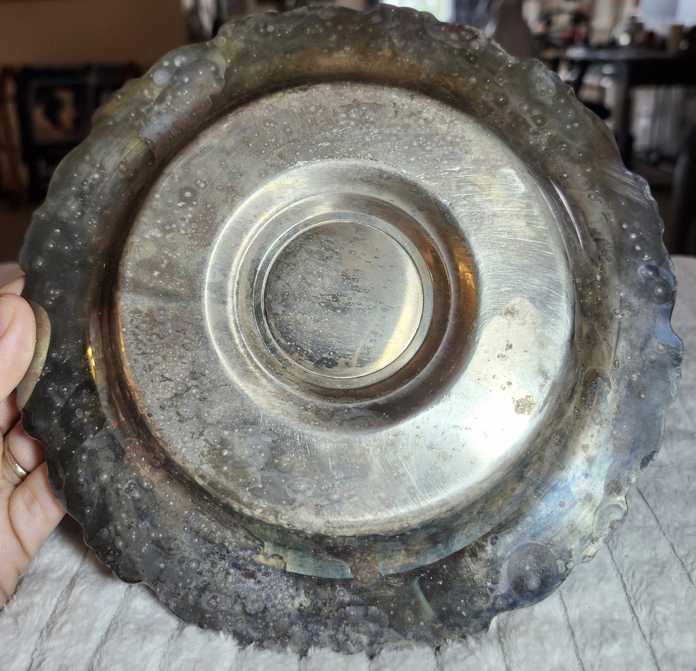 Silver-plated ornate bowl with attached underplate, possibly Oneida or Wallace.