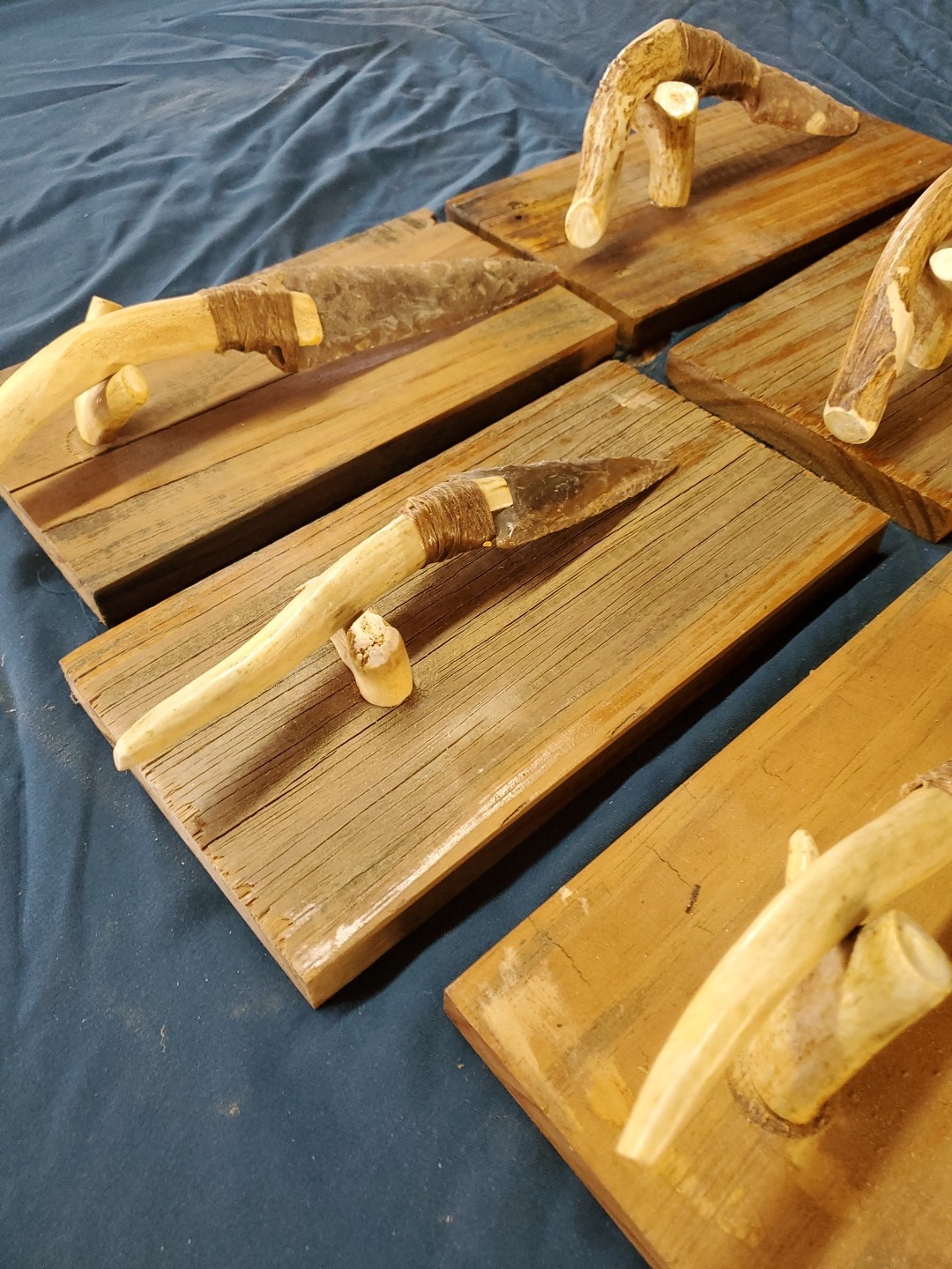 Flint Knapped Stone Arrowhead Blade Knife with Deer Antler Handle on Wood Stand