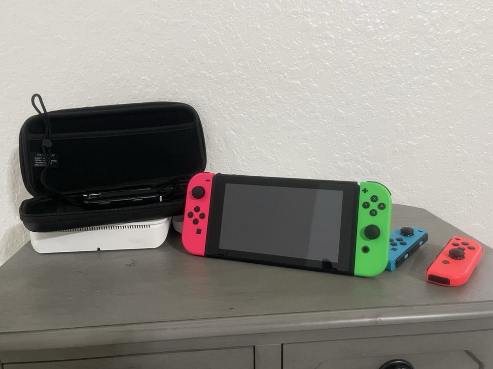 Nintendo Switch Including The Case, And Four Joy controllers.