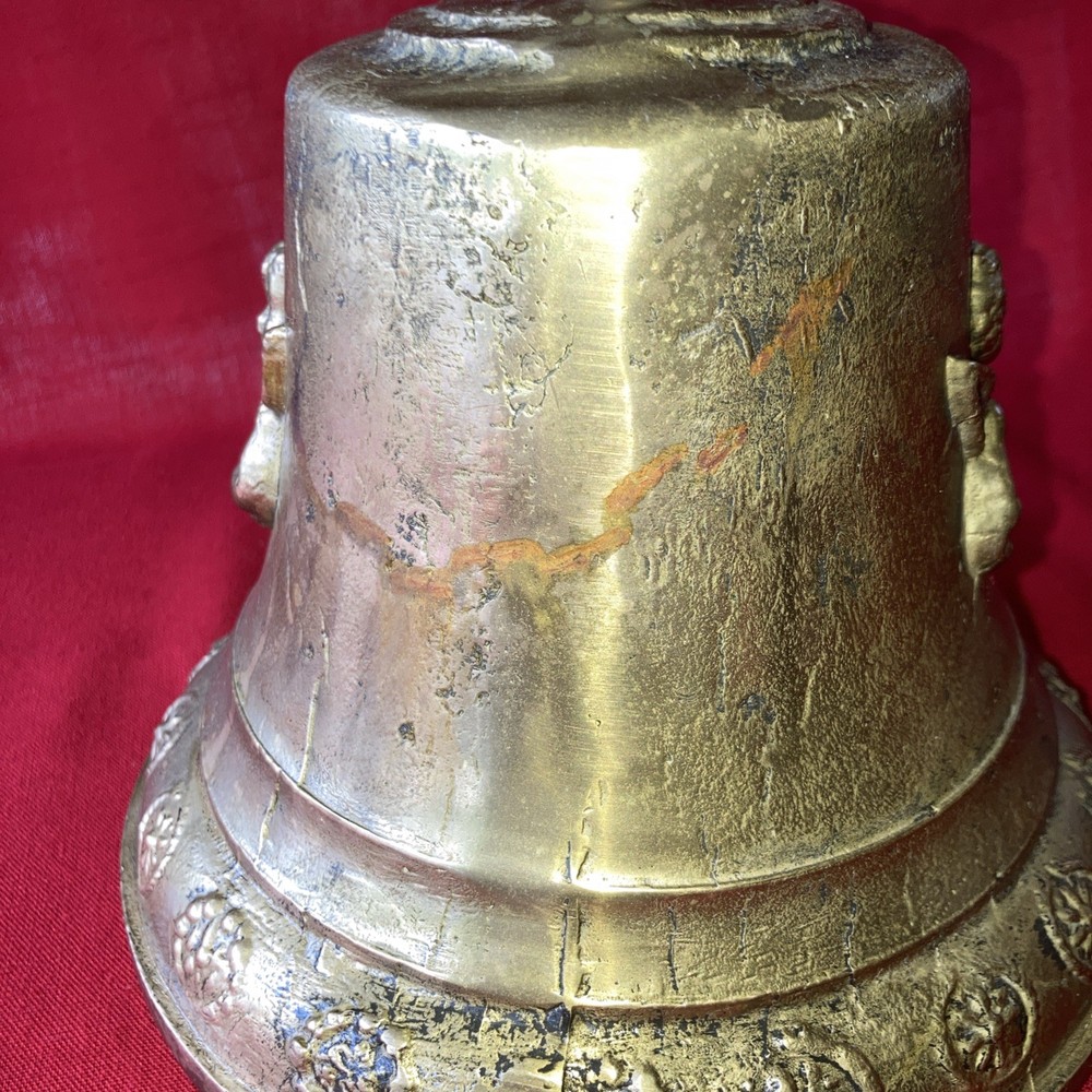 Heavy brass bell with Cupid on each side.