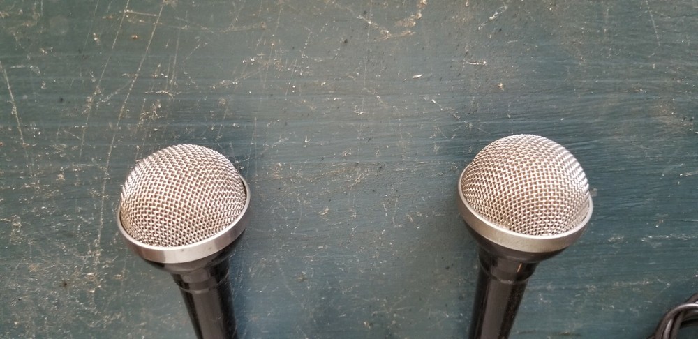 Two vintage wired microphones with metal/chrome/mesh tip