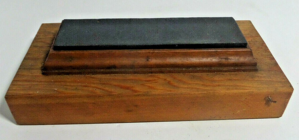sharpening stone mounted on wood base