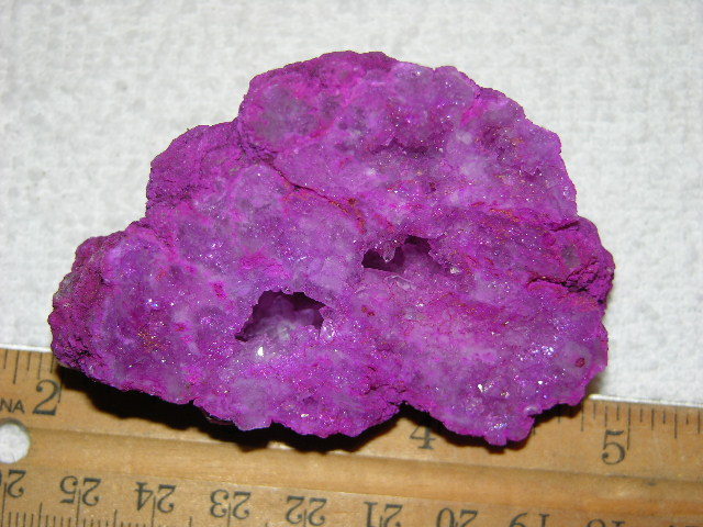 Geode cut & polished half with colored crystal center 3 inch E70