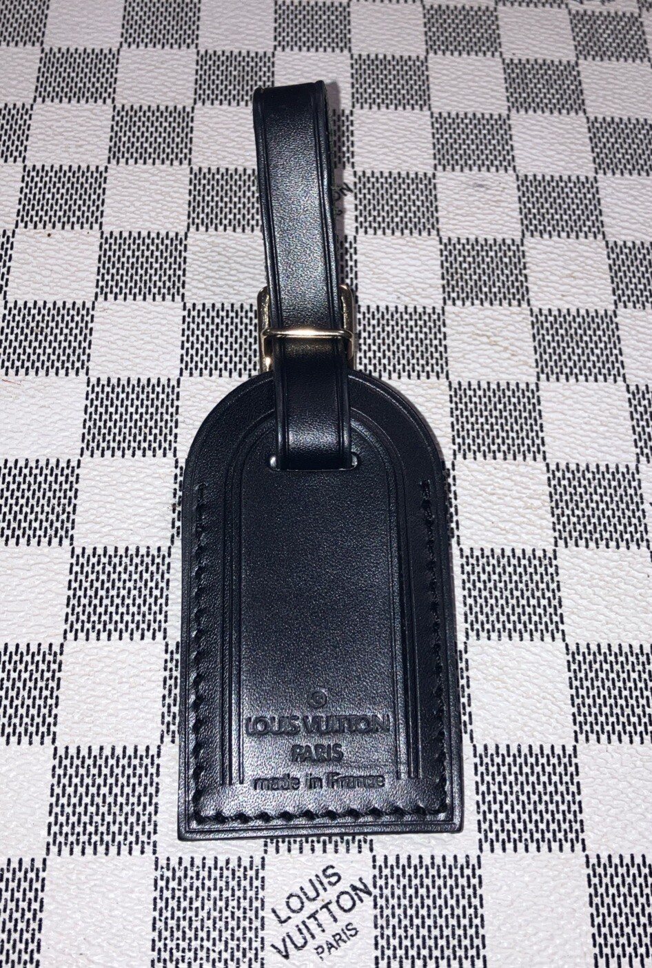Authentic Louis Vuitton small Black W/ Gold Hardware name tag.