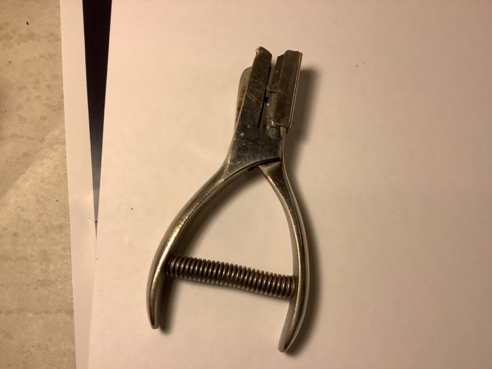 A.F. & Co. hole punch with spring handle action and adjustable punch depth guide