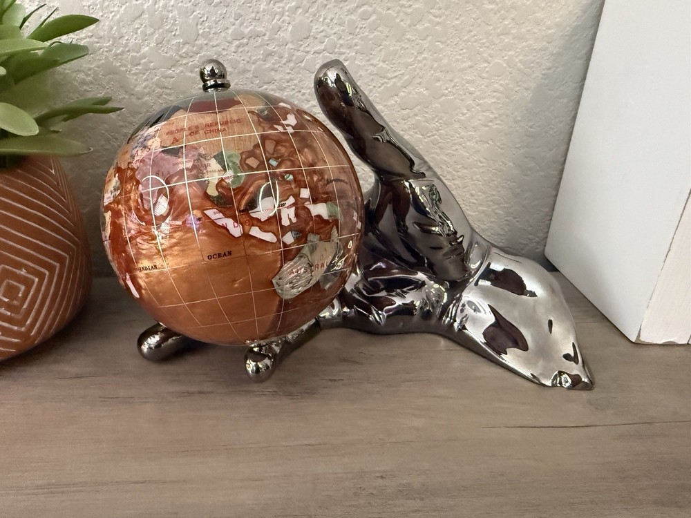 hand holding gemstone globe decor
