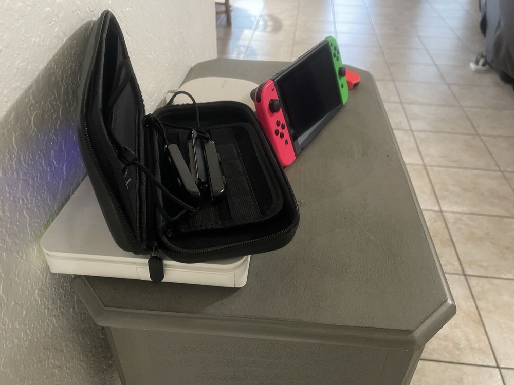 Nintendo Switch Including The Case, And Four Joy controllers.