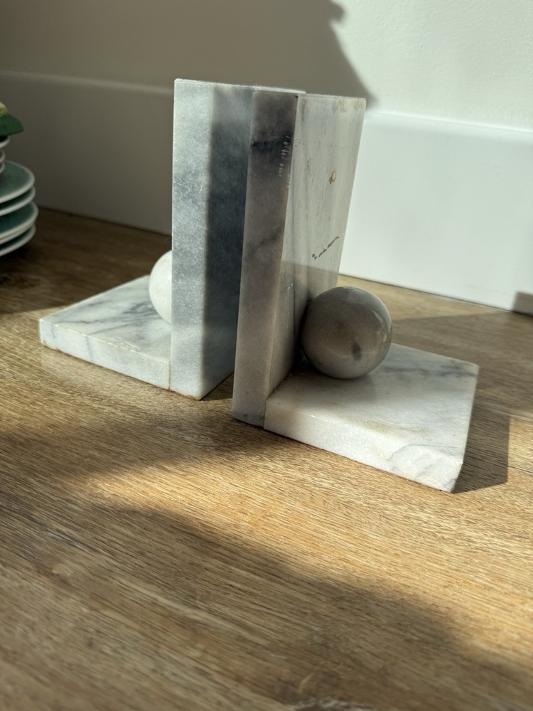 Vintage marble bookends with spherical elements.