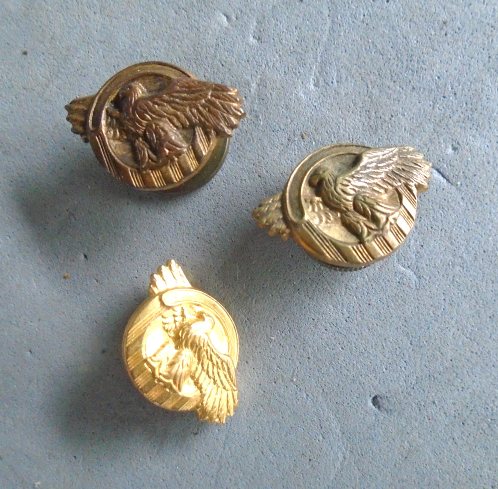 WWII screwback ruptured duck pins, one missing screw