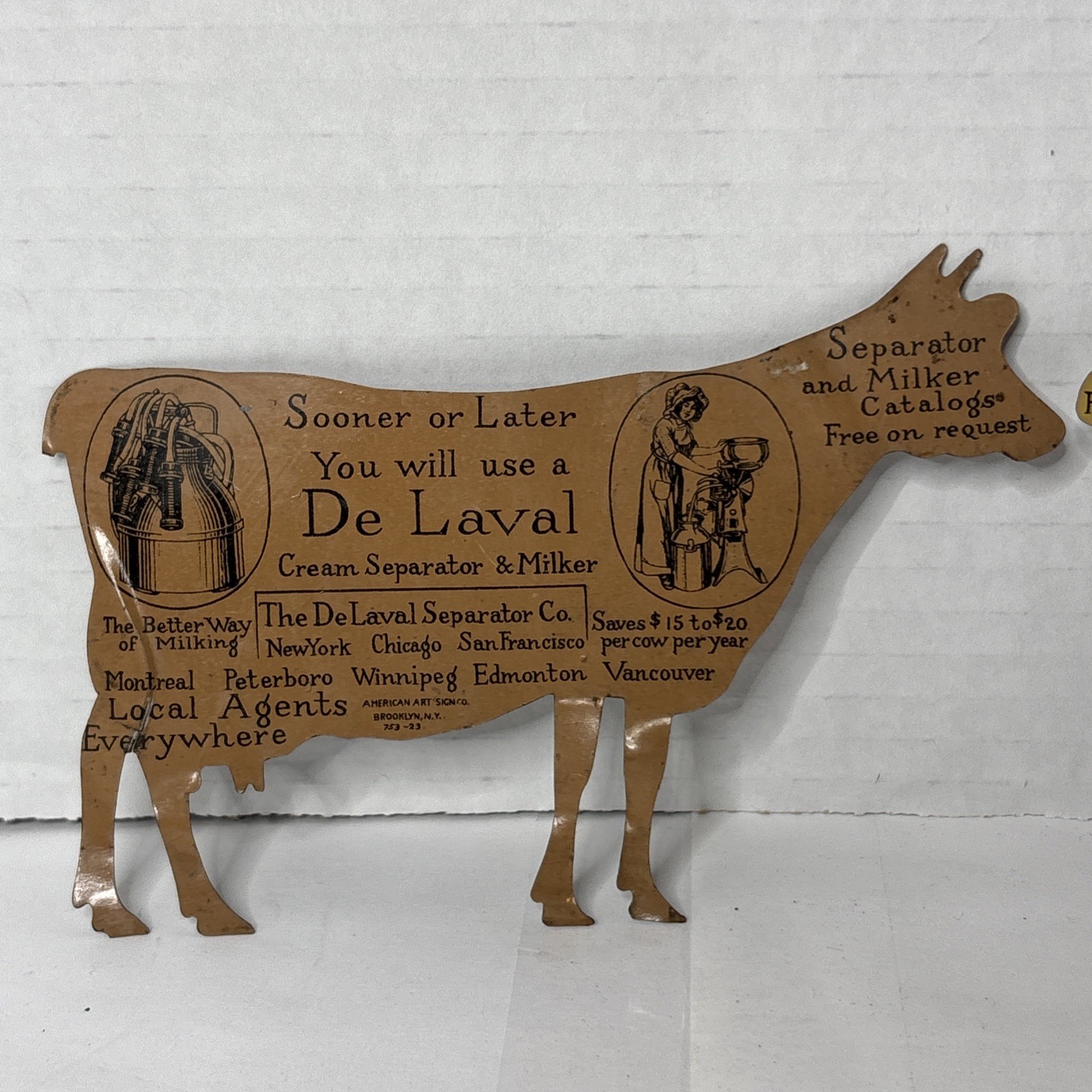 Pair of Antique DeLaval tin die cut cow and calf advertising cream separator ads