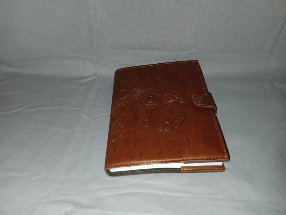 brown leather journal cover with an embossed rooster design. 