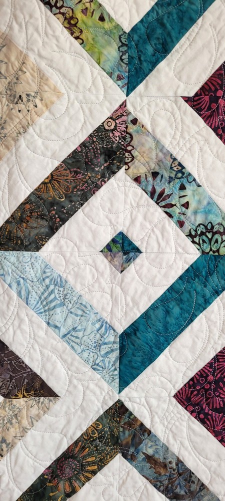 Hand made 55" X 62" Quilt In multiple batiks, purple batik back. Patchwork