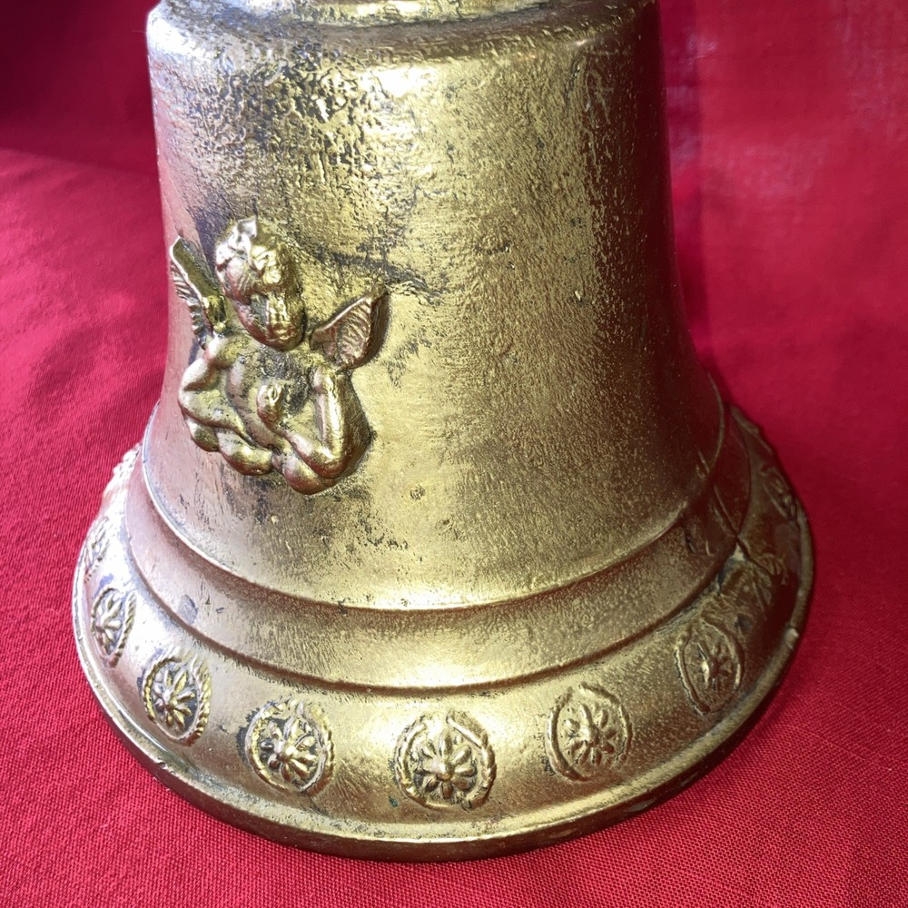Heavy brass bell with Cupid on each side.