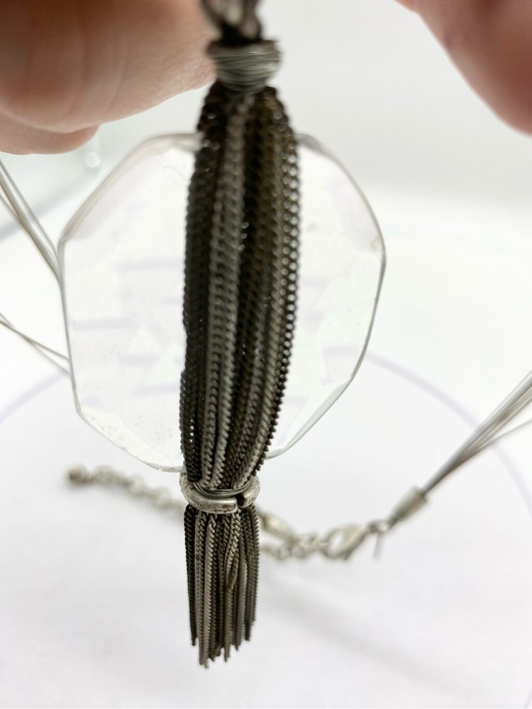 Clear large glass stone with multi layered chain silver tassel