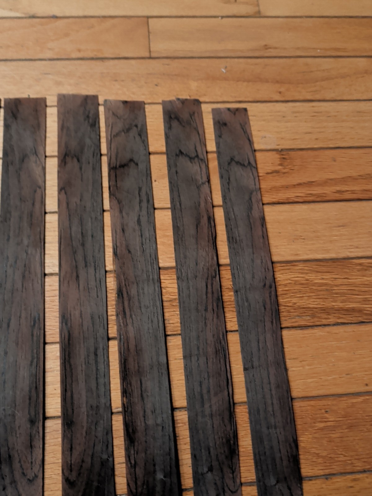 7 pieces of rosewood veneer 1 1/4" to 1 1/2" x 24 1/2" each raw 1/42"