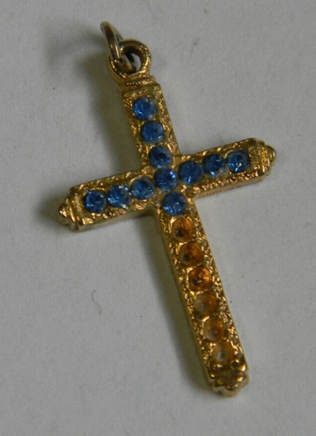 Religious gold tone missing blue stones cross pendant