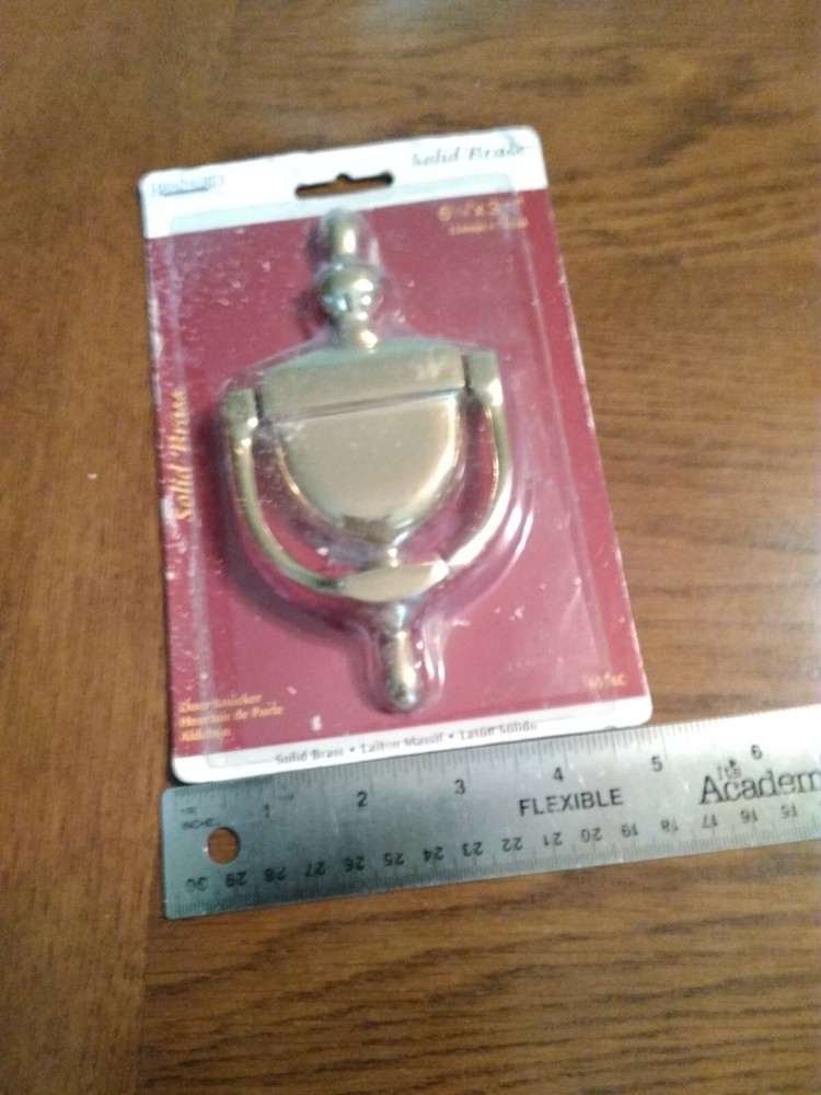 Brass Door Knocker. Unopened, but packaging rough. Solid.