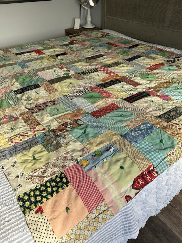 Handmade patchwork quilt with mixed fabric patterns